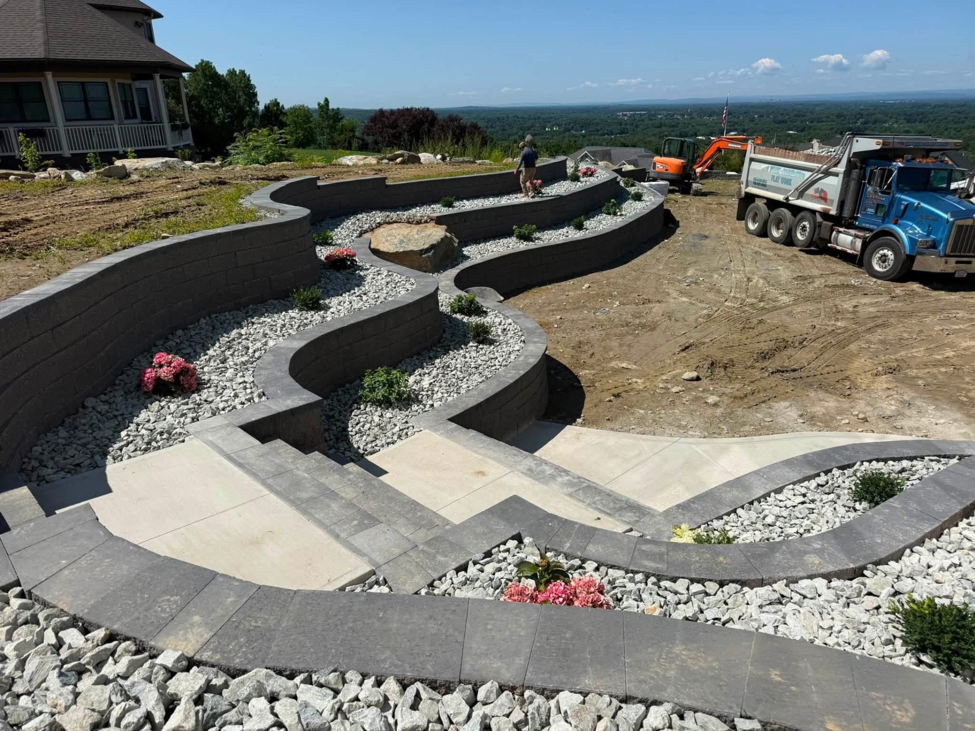 Curved block retaining walls and concrete walkways built by American Concrete & Asphalt